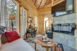 a living room with a couch and a table at Idaho Springs Cabin with Hot Tub on Half Acre! in Idaho Springs