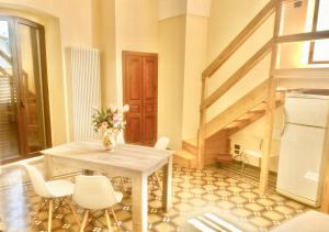 a dining room with a table and white chairs at Salento Soleluna in Matino