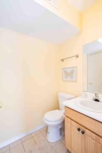 a bathroom with a white toilet and a sink at Gorgeous Waterfront 3 Bedroom, 1.5 Bathroom Unit. in New Haven