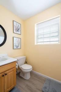 a bathroom with a toilet and a sink and a window at Gorgeous Waterfront 3 Bedroom, 1.5 Bathroom Unit. in New Haven