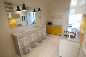 a kitchen with a sink and a counter with a mirror at d.Five Panorama Apartment Synagogue in Budapest