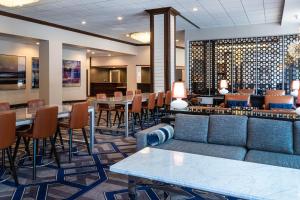 a lobby with a couch and tables and chairs at Sheraton Indianapolis City Centre Hotel in Indianapolis