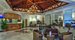 a lobby with chairs and a chandelier at Akka Claros Hotel - All Inclusive in Kemer