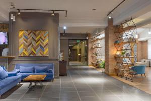 a lobby with blue couches in a building at Best Western Tbilisi Art Hotel in Tbilisi City