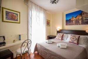 a bedroom with a bed with towels on it at B&B RE TANCREDI in Taormina +37 photos