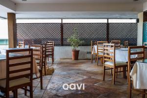 een eetkamer met tafels en stoelen in een restaurant bij Mirador Apart-hotel por Quarto à Vista in Natal