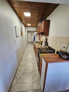 a kitchen with a counter and a stove top oven at La Casa de Kuky in Esquel