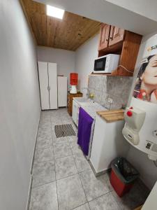 a small room with a kitchen with a microwave at La Casa de Kuky in Esquel +3 photos