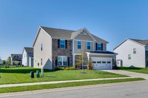 a large white house with blue windows and a driveway at Spacious Home with Fireplace - Near Golf! in Brownsburg