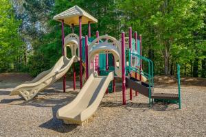 a playground with a slide in a park at Sunny Apex Vacation Rental with Pool Access! in Apex
