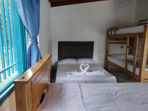 Postel nebo postele na pokoji v ubytování Hosteria Puerta del Nus