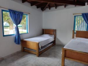 Postel nebo postele na pokoji v ubytování Hosteria Puerta del Nus
