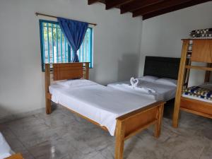 Postel nebo postele na pokoji v ubytování Hosteria Puerta del Nus