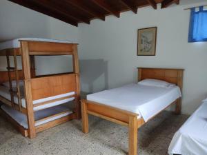 Postel nebo postele na pokoji v ubytování Hosteria Puerta del Nus