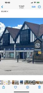 a large black and white building with a clock on it at West Highland Way Rooms ED30002F in Milngavie