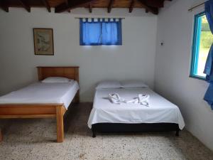 Postel nebo postele na pokoji v ubytování Hosteria Puerta del Nus