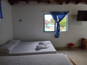 Postel nebo postele na pokoji v ubytování Hosteria Puerta del Nus