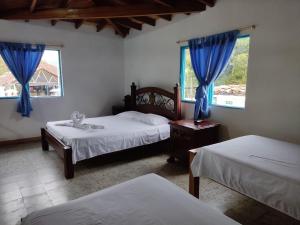 Postel nebo postele na pokoji v ubytování Hosteria Puerta del Nus