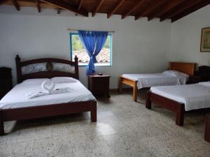Postel nebo postele na pokoji v ubytování Hosteria Puerta del Nus