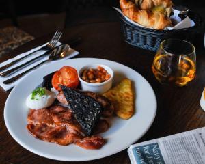 a plate of breakfast food on a table at The Swan at Tarporley in Tarporley