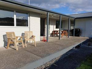 two chairs and a table on a patio at Kiwiana Gem in Reefton +4 photos