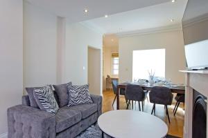 a living room with a couch and a table at Hyde Park Paddington spacious London Home in London