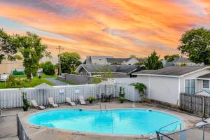 a pool in a yard with chairs and a house at 21 Rehoboth Beach House --- 20494 Coastal Highway, Unit #21 in Rehoboth Beach