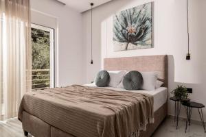 a bedroom with a large bed and a window at Melissia Luxury Villa in Zakynthos Town +61 photos