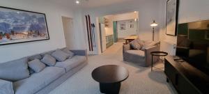 a living room with a couch and a table at Cedarwood Apartments in Falls Creek