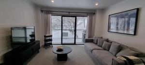 Cedarwood Apartments في فولز كريك: غرفة معيشة مع أريكة وطاولة
