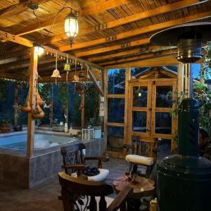 a large room with a tub and tables and chairs at Casa Campestre EL CAPRICHO Fúquene in Fúquene