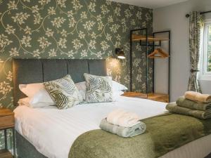 a bedroom with a large bed with a large white comforter at Swallow Lodge - Uk42540 in Winforton
