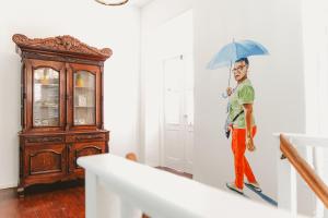 a man is holding an umbrella in a room at Bario Hotel in Willemstad