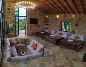 a large living room with couches and stained glass windows at Zona C cabañas in Socorro