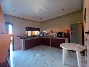a kitchen with a white table and a refrigerator at Villa in Agadir