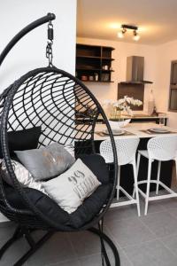 a swing chair with pillows in a living room at Iaorana Pamatai accomodation in Faaa