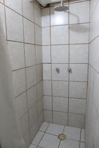 a bathroom with a shower with a drain at Hostal Purísima in San Francisco del Rincón