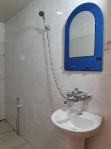 a bathroom with a sink and a mirror on the wall at BAKU GUEST HOSTEL in Baku