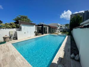 a swimming pool in the backyard of a house at CasaMar House Whit Pool 3 Bedrooms 3 Bathrooms in San Juan