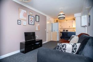 Spacious 1 Bed- Nunhead/Peckham-sleeps 4 في لندن: غرفة معيشة مع أريكة وتلفزيون