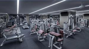 a gym with a lot of cardio equipment in it at Fantastic palms place with strip views 23rd floor in Las Vegas