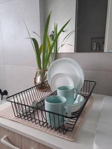 a tray with plates and cups on a kitchen counter at Unwind in Woombye in Woombye