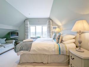 um quarto com uma cama grande e uma janela em Long Meadow em Midhurst