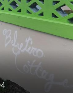 zielony mur z graffiti na boku budynku w obiekcie Belretiro Cottage w mieście Bel Retiro
