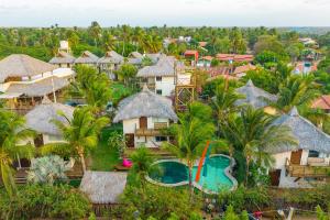 an aerial view of a resort with a pool and palm trees at Vilarejo Barra Grande in Barra Grande