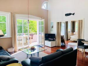 a living room with a couch and a glass table at Strandquartier 31 "Quartier 1" in Wustrow