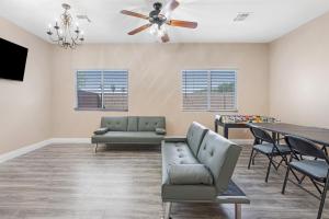 a living room with a couch and a table at Beautiful Spacious Single Story Vegas Home in Las Vegas