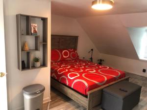 a bedroom with a bed with a red comforter at roceruzdevelopments llc in Baltimore