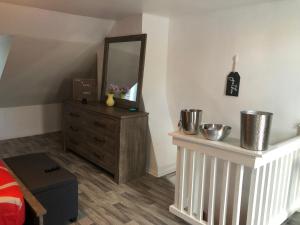 a bedroom with a dresser and a mirror at roceruzdevelopments llc in Baltimore