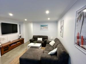 a living room with a couch and a flat screen tv at Vasse Terrace in Vasse